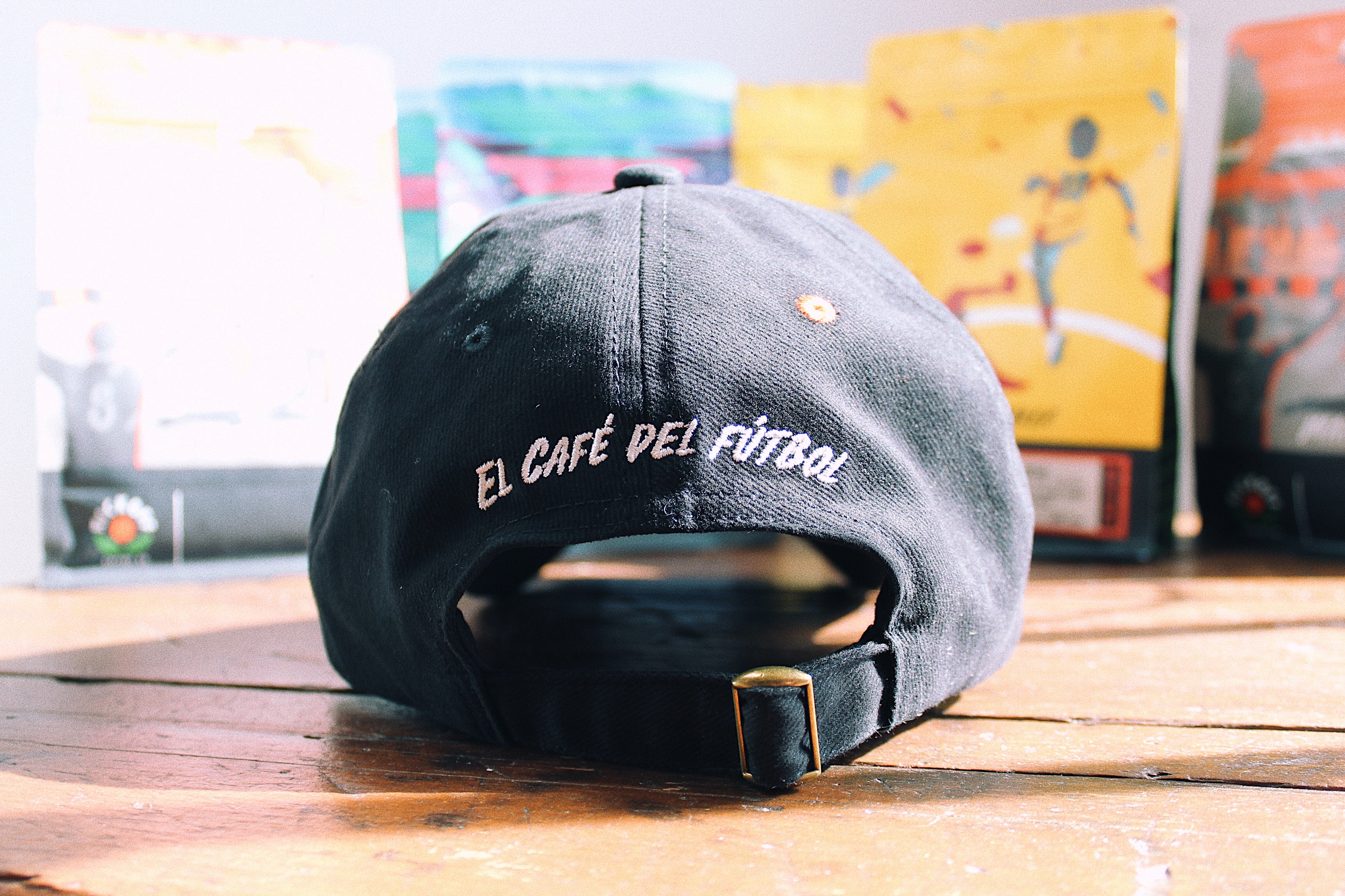 black hat with El Cafe del Futbol Logo embroidered on the back